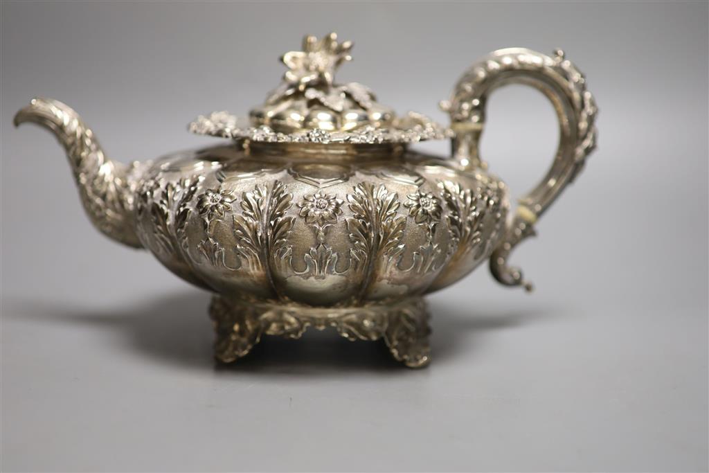 A George IV silver squat melon shaped teapot, embossed with flowers, The Barnards, London, 1829, gross 28oz.